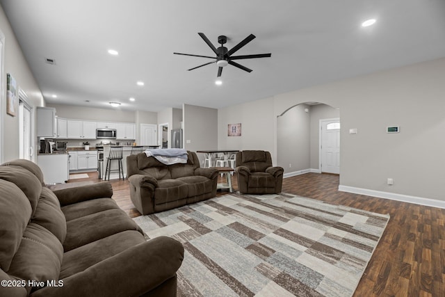 living room with ceiling fan and light wood-type flooring