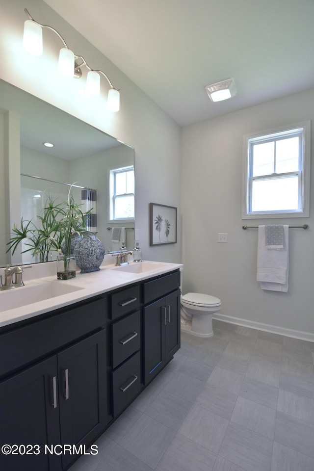 bathroom featuring vanity, toilet, and an enclosed shower