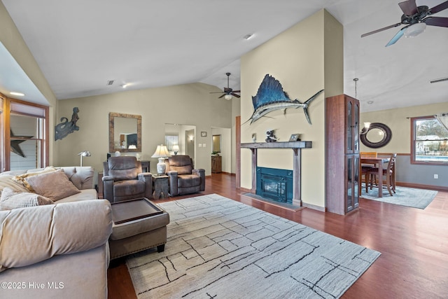 living room featuring wood-type flooring, lofted ceiling, and ceiling fan