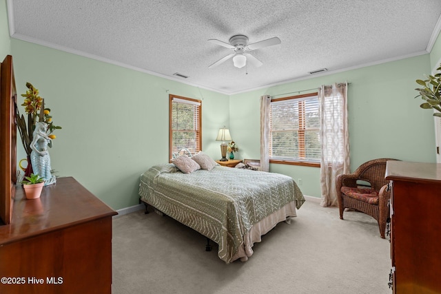 carpeted bedroom with crown molding, ceiling fan, and a textured ceiling