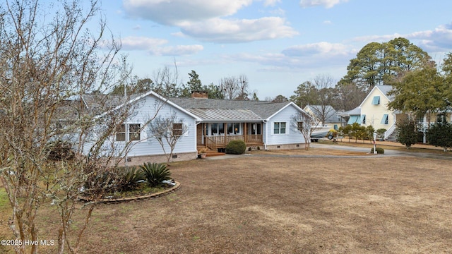 ranch-style home with metal roof, a porch, crawl space, a standing seam roof, and a chimney