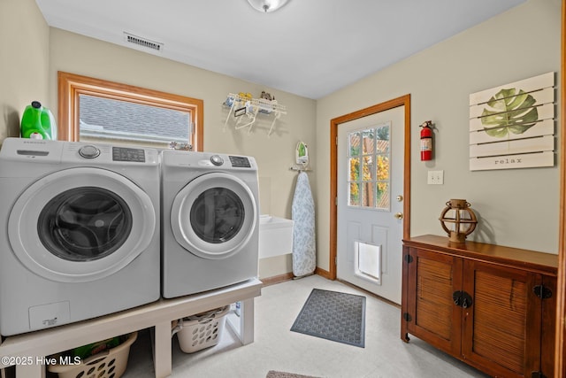 washroom featuring plenty of natural light and separate washer and dryer