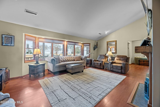 living room featuring hardwood / wood-style floors and vaulted ceiling