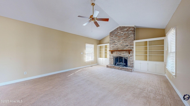 unfurnished living room featuring a fireplace, vaulted ceiling, and light carpet