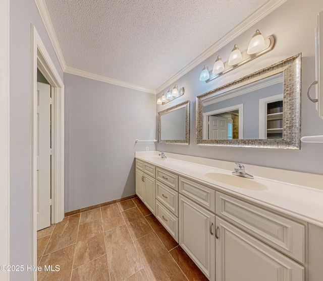 bathroom with crown molding, vanity, and a textured ceiling