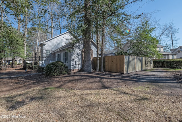 view of side of home with a yard