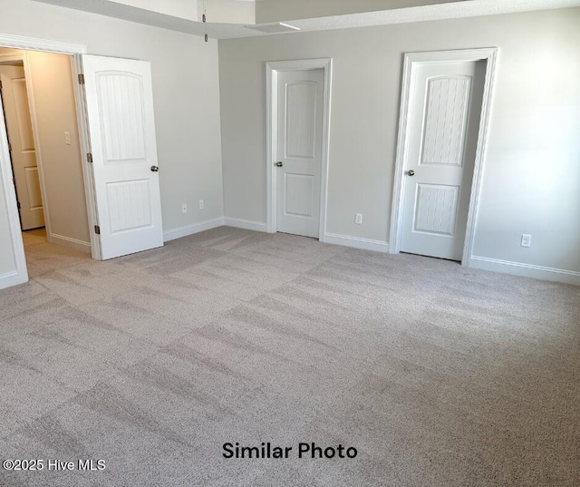 unfurnished bedroom with light carpet