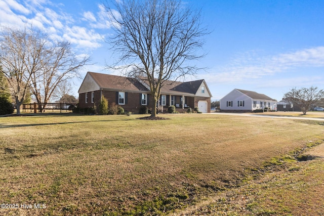 view of front of property with a front yard and a garage