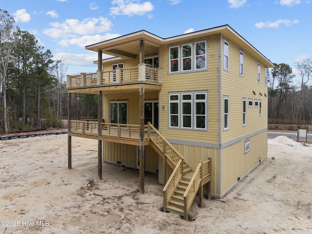 rear view of property with a balcony and a deck