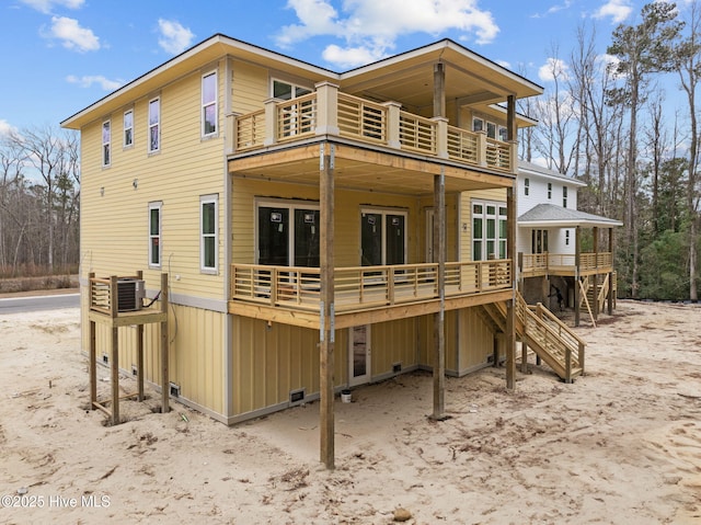 back of property with a wooden deck and central AC unit