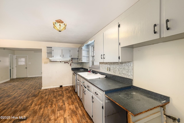 kitchen with white cabinetry, dark hardwood / wood-style floors, tasteful backsplash, stainless steel dishwasher, and sink