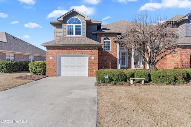 view of front of property featuring a shingled roof, brick siding, driveway, and a front lawn