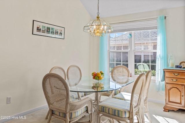 dining room with baseboards, a chandelier, a wealth of natural light, and light colored carpet