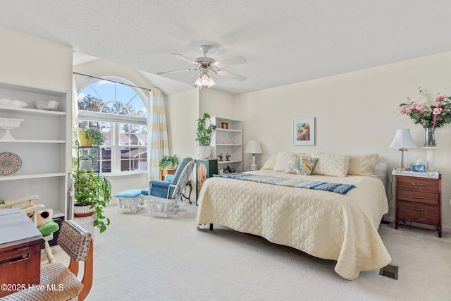 bedroom featuring carpet, a ceiling fan, and a textured ceiling