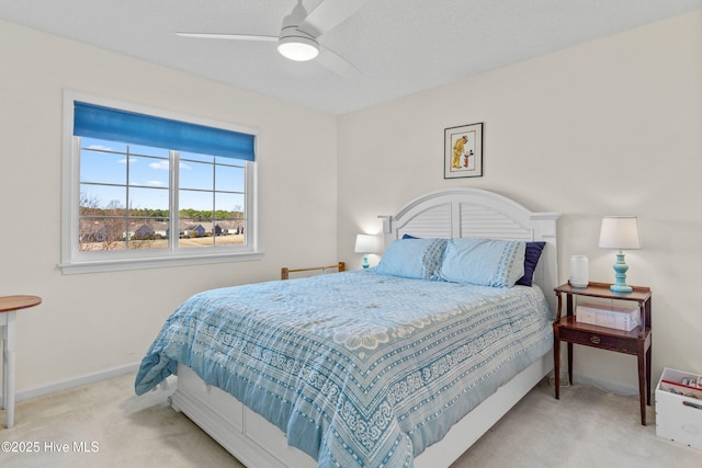 carpeted bedroom featuring ceiling fan and baseboards