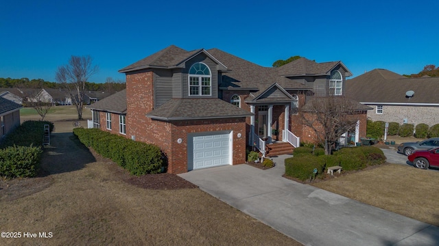 view of front of property with a garage, a front lawn, concrete driveway, and brick siding