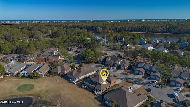 birds eye view of property with a water view, a residential view, and a view of trees