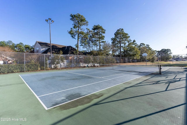 view of sport court featuring fence