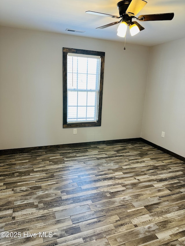 spare room with hardwood / wood-style flooring and ceiling fan