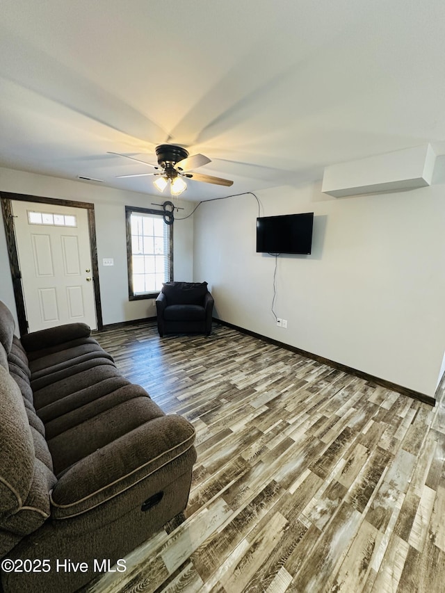 unfurnished living room featuring ceiling fan and hardwood / wood-style flooring