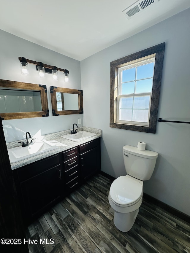 bathroom with vanity, wood-type flooring, and toilet