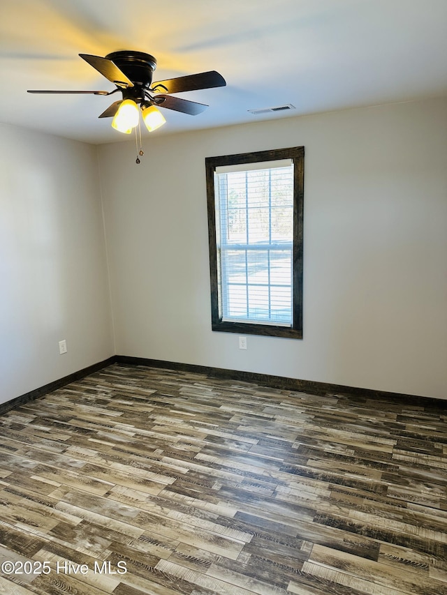 empty room with hardwood / wood-style flooring and ceiling fan