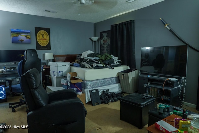 interior space with a textured ceiling, ceiling fan, and carpet floors