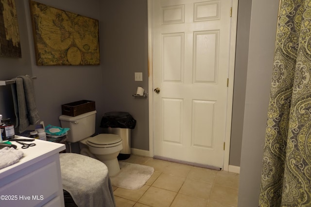 bathroom with tile patterned flooring, vanity, and toilet