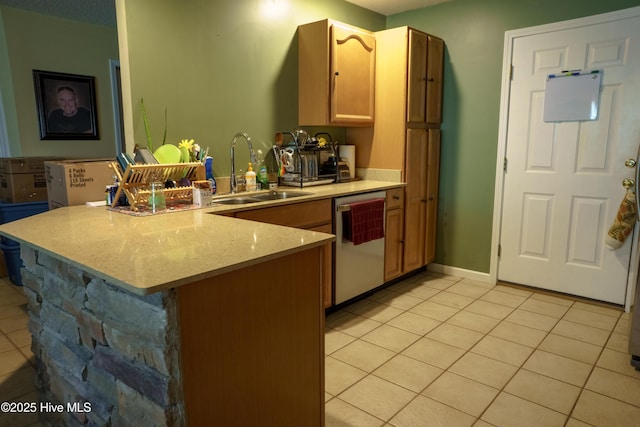 kitchen with kitchen peninsula, light tile patterned floors, light stone counters, sink, and stainless steel dishwasher