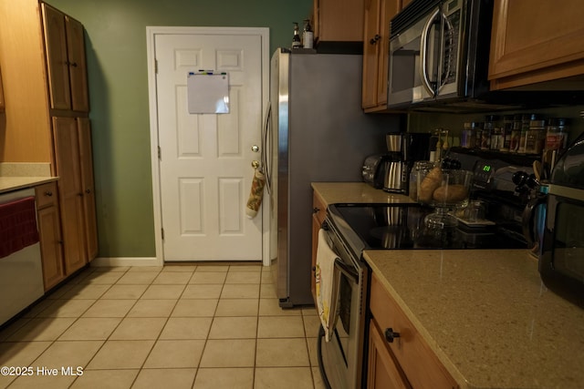 kitchen with stainless steel appliances and light tile patterned floors