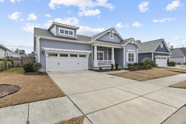 craftsman house with a garage, covered porch, and a front lawn