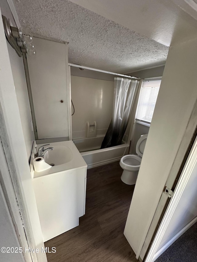 full bathroom featuring toilet, wood-type flooring, shower / bathtub combination with curtain, and a textured ceiling