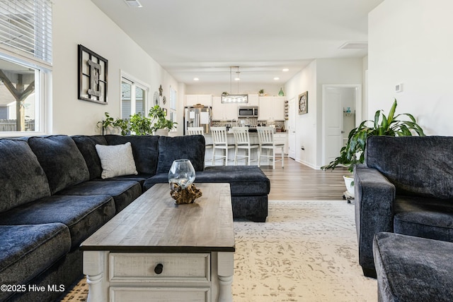 living room with light hardwood / wood-style flooring