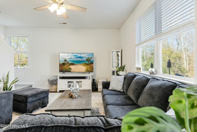 living room with ceiling fan and light wood-type flooring