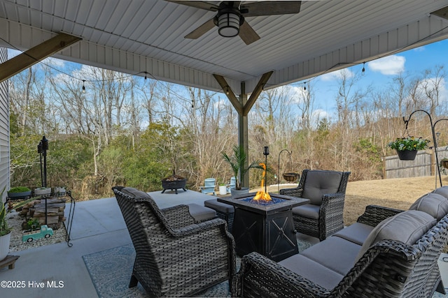 view of patio with an outdoor living space with a fire pit and ceiling fan