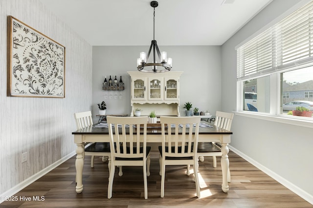 dining space with an inviting chandelier and hardwood / wood-style floors