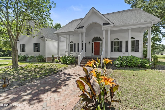 132 Lake Wood Dr, Edenton, NC 27932 - neoclassical home featuring covered porch, a shingled roof, and a front yard