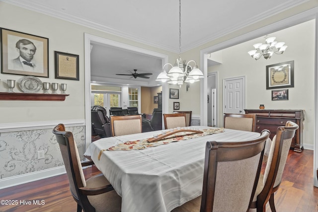 dining area featuring crown molding, ceiling fan with notable chandelier, and dark hardwood / wood-style flooring