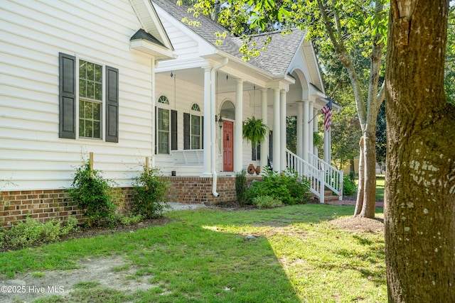 132 Lake Wood Dr, Edenton, NC 27932 - view of exterior entry featuring a shingled roof, covered porch, and a yard