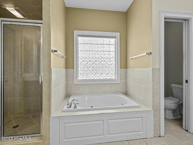 bathroom with tile patterned floors, toilet, and independent shower and bath