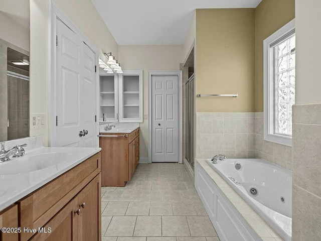 bathroom featuring vanity, tile patterned floors, and plus walk in shower