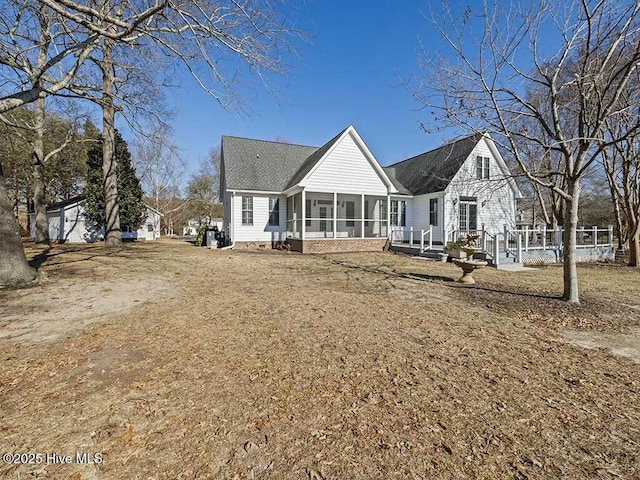 rear view of house with a sunroom