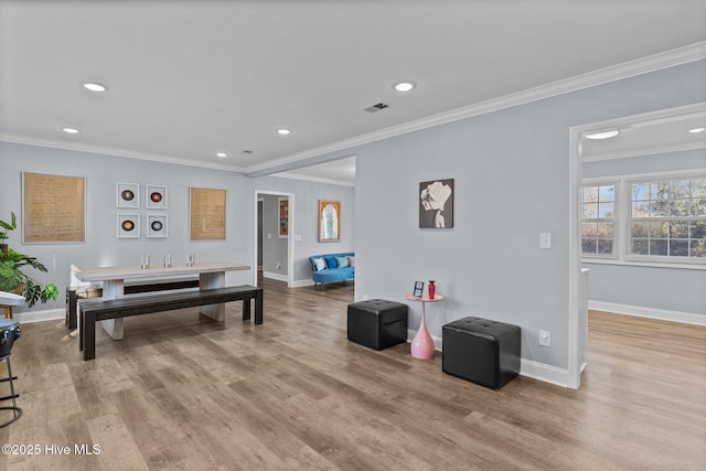 living room with light hardwood / wood-style flooring and ornamental molding