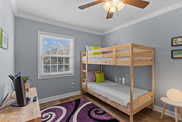 bedroom with crown molding, ceiling fan, and hardwood / wood-style floors