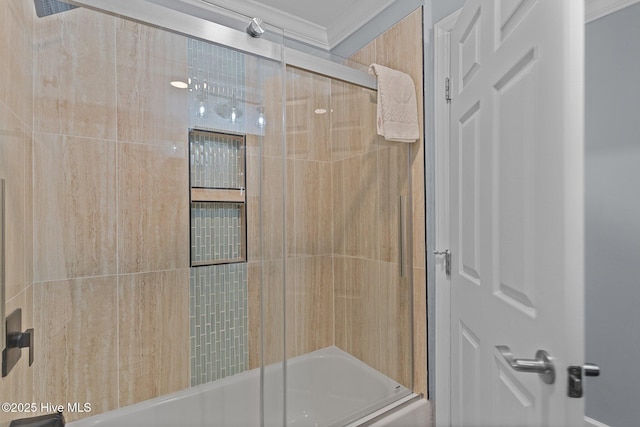 bathroom featuring ornamental molding and bath / shower combo with glass door