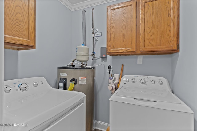 laundry area with cabinets, ornamental molding, washing machine and clothes dryer, and water heater