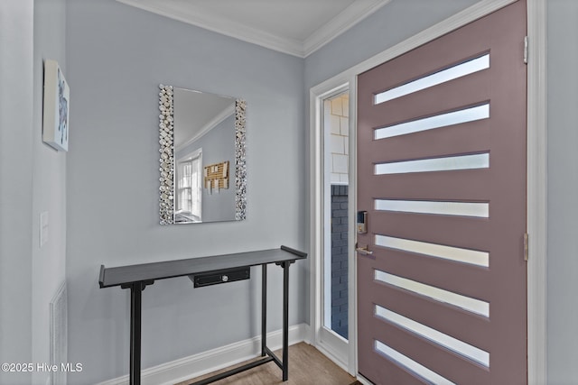 foyer with crown molding and light wood-type flooring