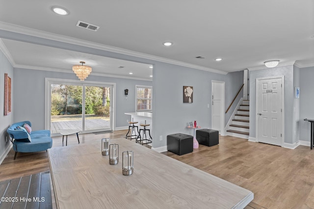 dining area featuring wood-type flooring and ornamental molding