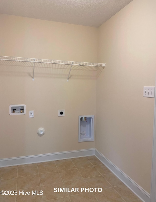 washroom with washer hookup, electric dryer hookup, tile patterned floors, gas dryer hookup, and a textured ceiling