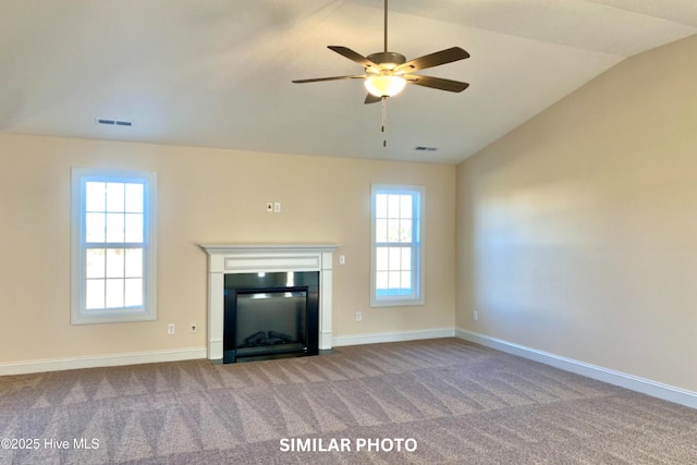 unfurnished living room featuring a wealth of natural light, carpet, lofted ceiling, and ceiling fan